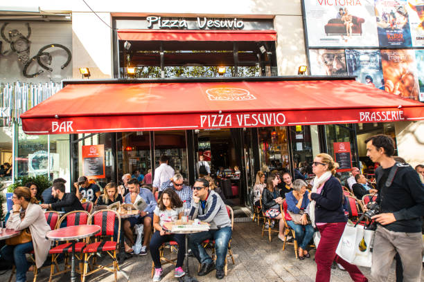 Paris, France - September 25, 2016: People eating outdoors in a cafe on Avenue des Champs-Elysees.