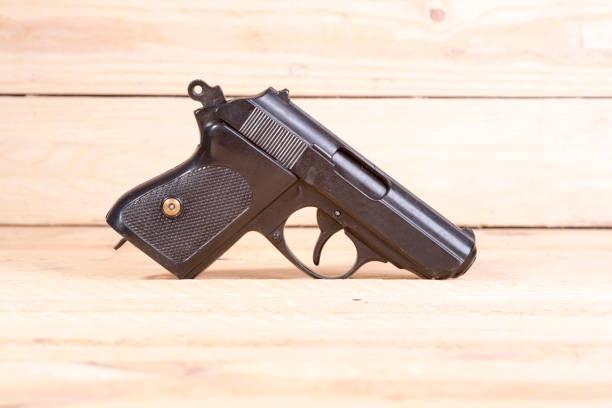 istock 9 mm gun and bullets strewn on the table. 645767878