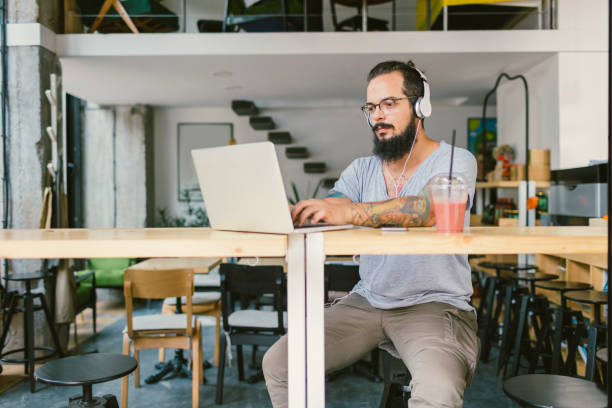istock Bearded man working on laptop in cafe 645771314