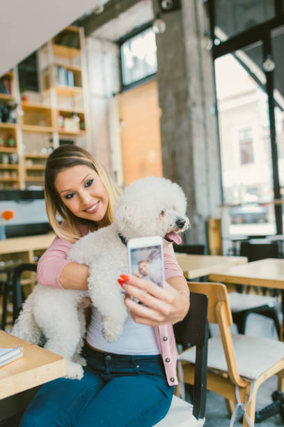 istock Young Woman Making selfie In Cafe With Her Dog. 645773912