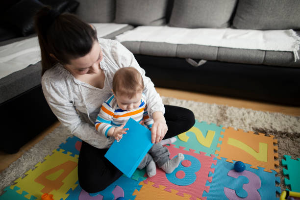 istock Mother reading book with child 645774116