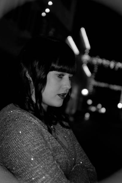 istock Young woman outdoors in town at night 645776426