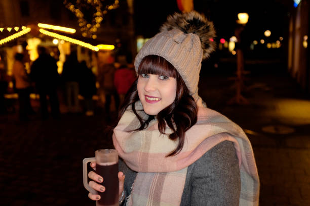 istock Young woman outdoors in town at night 645776448