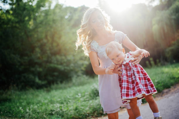 istock woman with a child on a walk on a sunny day 645776564