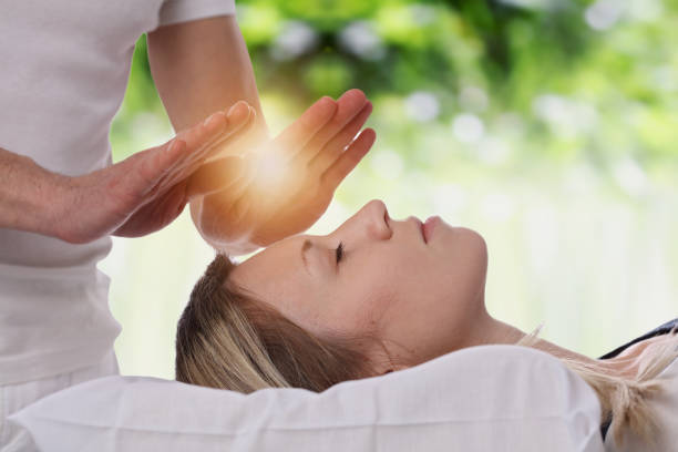 Woman having reiki healing treatment , alternative medicine concept. Woman having reiki healing treatment , alternative medicine concept. reiki stock pictures, royalty-free photos & images