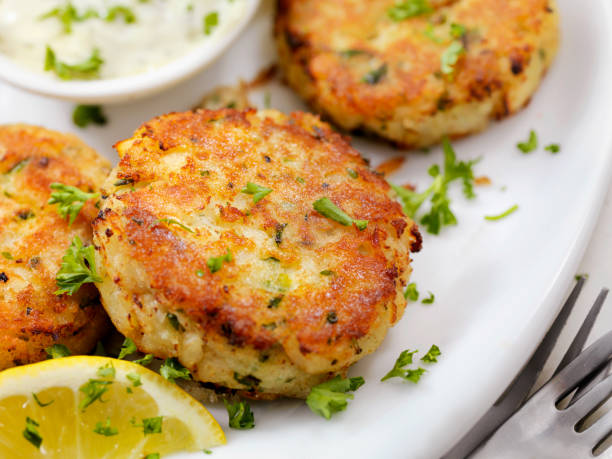 Crispy Golden Fish Cakes Halibut Fish Cakes with Lemon and Tartar Sauce crab photos stock pictures, royalty-free photos & images