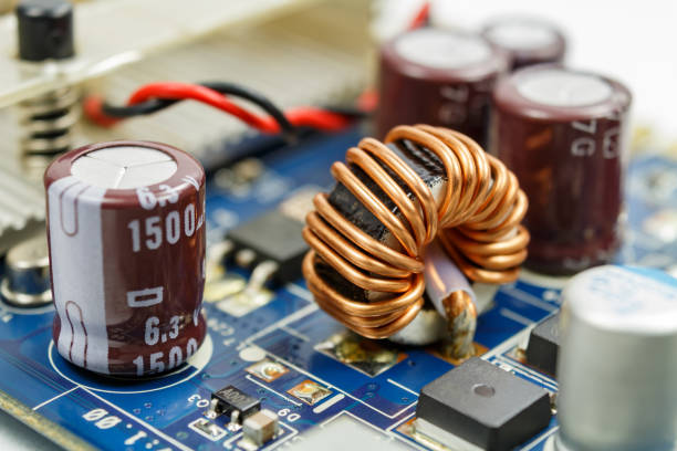 istock Transformer on a ferrite ring on the circuit board closeup 645778122