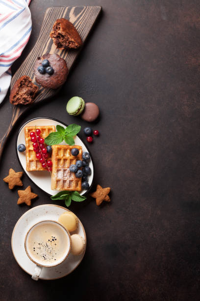 istock Coffee, sweets and waffles with berries 645780172