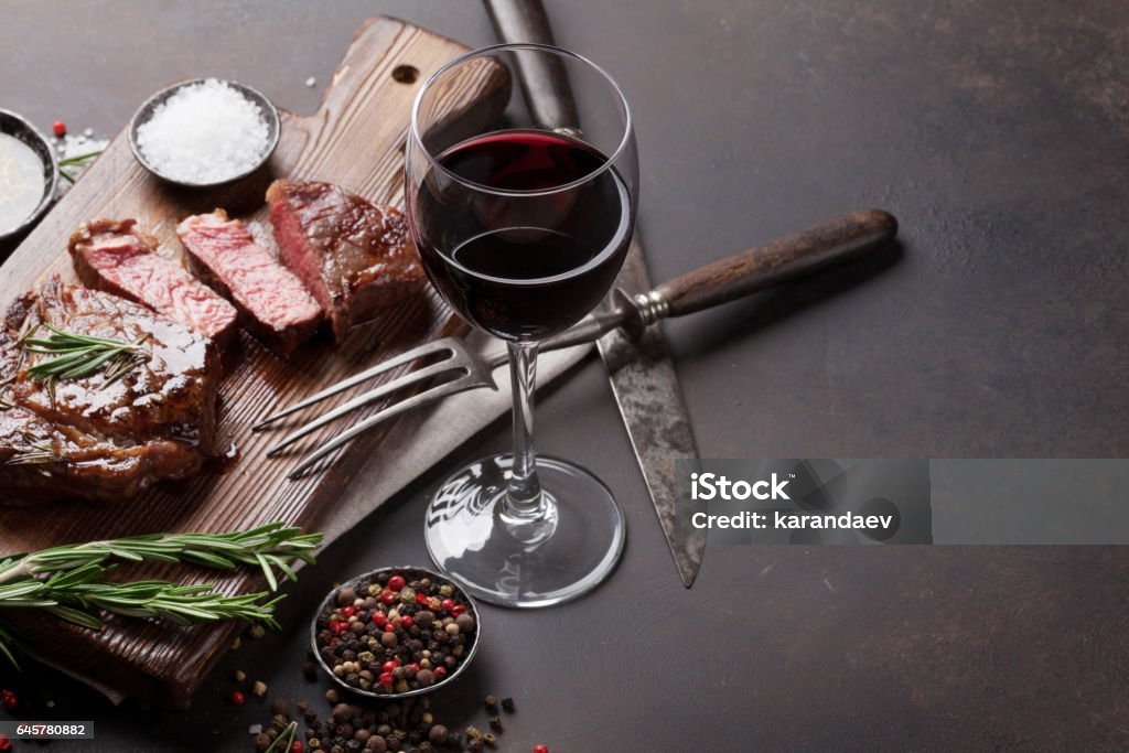 A la parrilla bistec de ribeye con vino tinto, hierbas y especias - Foto de stock de Vino libre de derechos