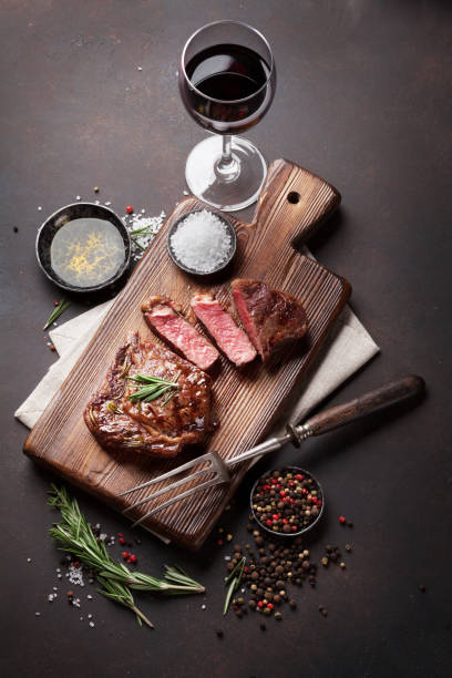 istock Grilled ribeye beef steak with red wine, herbs and spices 645780950