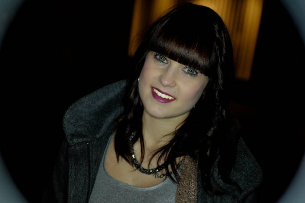 istock Young woman outdoors in town at night 645781656