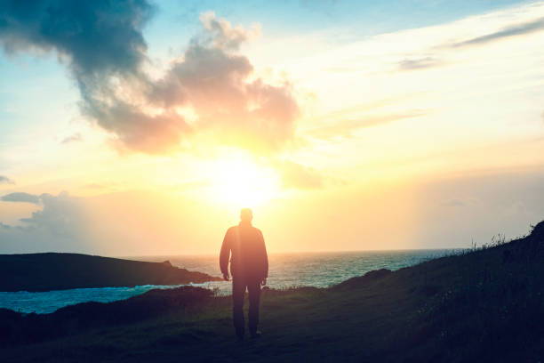 istock Man walking at Sunset, Pentire Headland, Newquay, Cornwall, September 645788272
