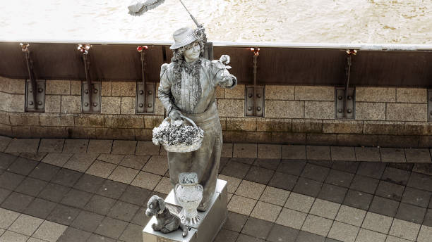 Hamburg, Germany - October, 10, 2016: Living statue street performer in Hamburg port poses to attract tourists and gapers. Living statues acting is a popular way to entertain passersby and tourists.