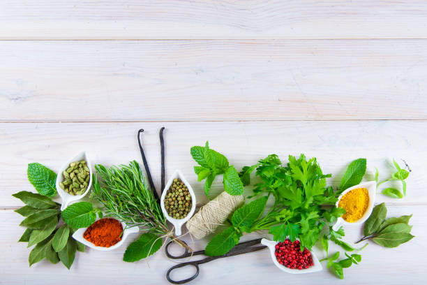 istock Fresh herbs and spices on a white wooden background 645792022