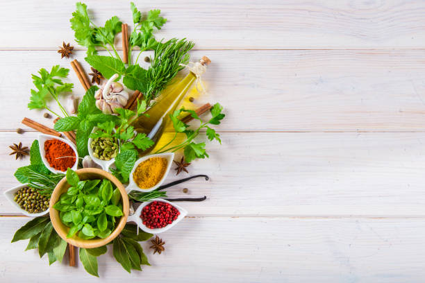istock Fresh herbs and spices on a white wooden background 645794570
