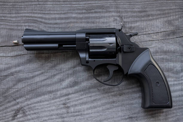 istock Black revolver with a bullet. 645795622