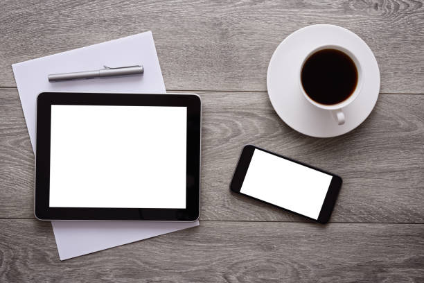 istock Blank white screen tablet pc and smart phone on desk 645799040