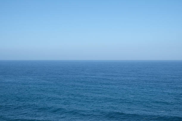 istock ocean horizon - clear blue sky background 645802022