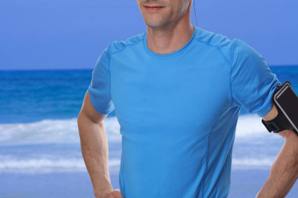 Fitness muscular man standing before or after workout exercising. Preparing for or rest after sport activity. Sport, recreation and healthy lifestyle concept