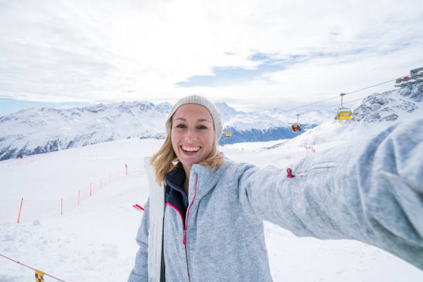 istock Young woman taking selfie on ski slopes 645803080