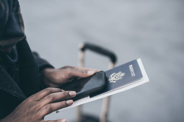 Young African American woman at airport holding passport