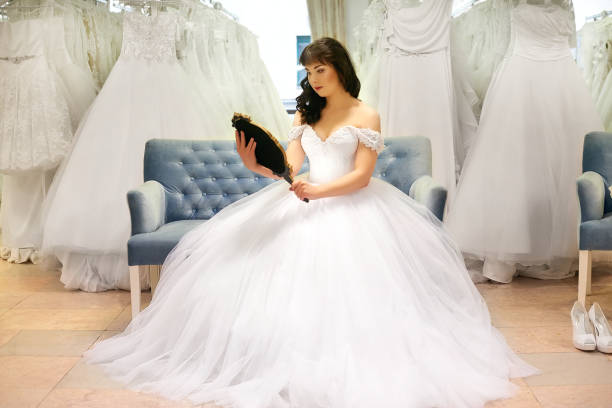 istock The bride looks at the mirror 645803630