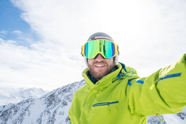 istock Young man taking selfie in ski slope, Switzerland 645807982