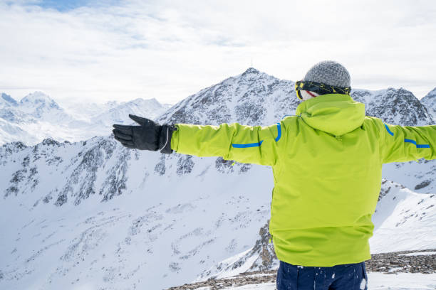 istock Young man on ski slopes arms outsretched 645808048