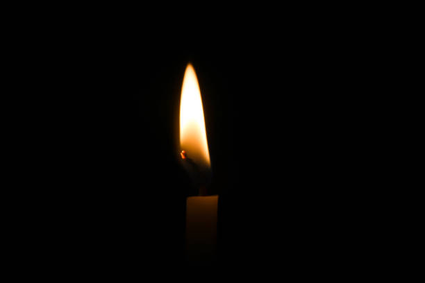 istock Candle burning brightly in the black background 645810700