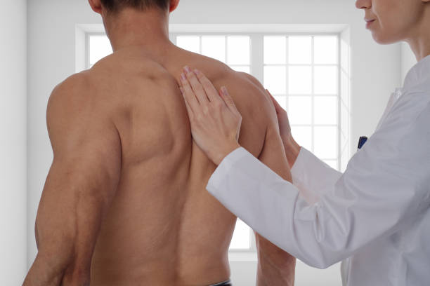 istock Chiropractic, osteopathy, dorsal manipulation. Therapist doing healing treatment on man's back . Alternative medicine, pain relief concept. 645810964