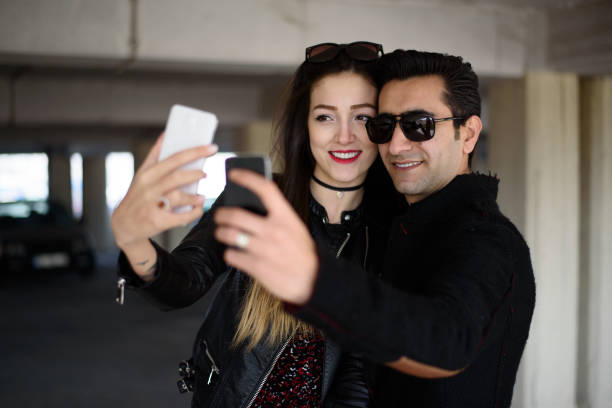 istock Young happy couple taking a selfie with smartphone 645815576