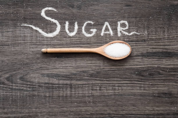 istock Word sugar created from sugar on the wooden background. 645817942