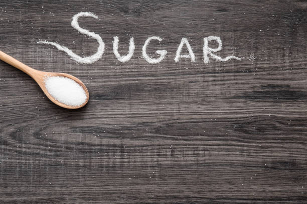 istock Word sugar created from sugar on the wooden background. 645817982