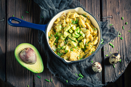 Healthy scrambled eggs with avocado for breakfast