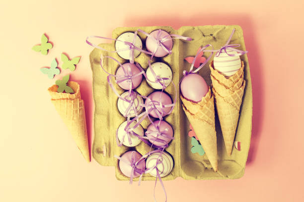 istock Easter or Spring, Food Concept. Fresh Eggs in Box for Eggs with Ice Cream Cones on Pink Pastel Background. 645818710