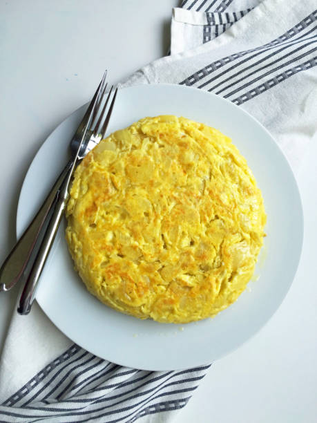 istock Spanish Potato Omelette whole on white plate 645826988