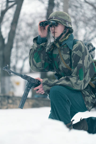 istock Soldier looking at target through binoculars at firing field 645833916