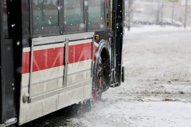 Bus struggling to walk on the snow, street, problems caused by a snowstorm
