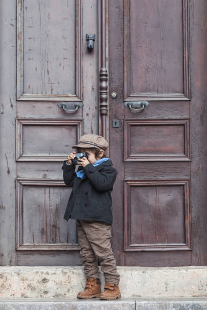 istock Portrait Of Little Boy Posing With His Camera 645836888