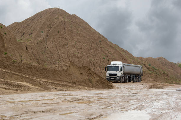 istock machine on sand quarry on a rainy day 645837054