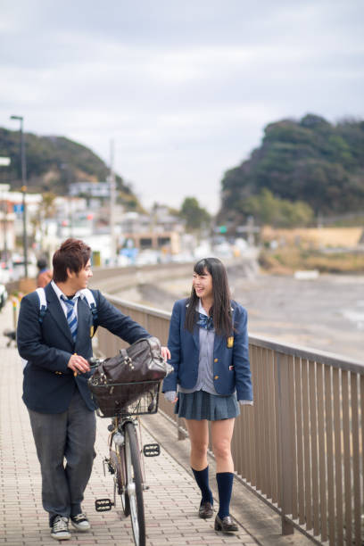 istock High school student couple walking together to school 645837352