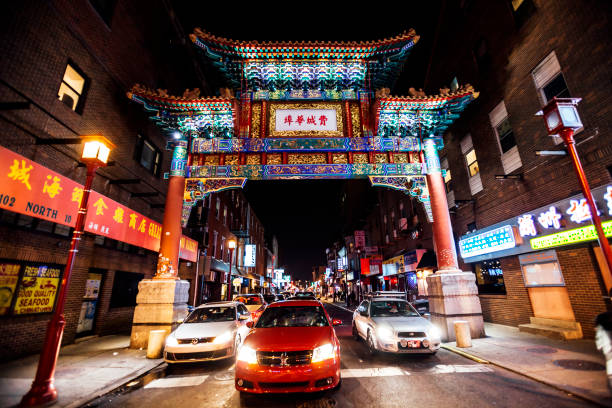 Philadelphia, Pennsylvania, USA - December 23, 2016: Night traffic in colourful Chinatown district, there is the famous Friendship Gate.