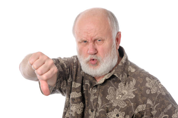 istock Senior man shows thumbs down gesture, isolated on white 645838216