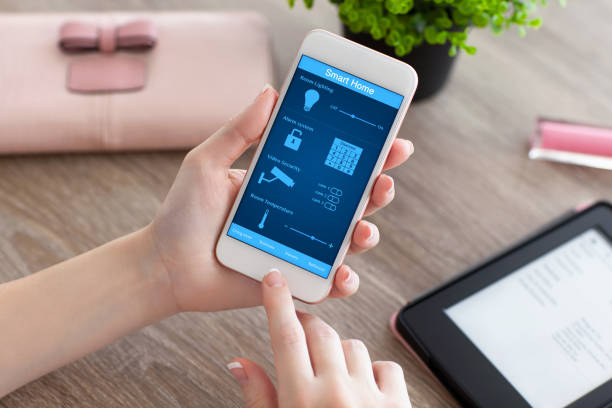 istock female hands holding phone with app smart home on screen 645838846
