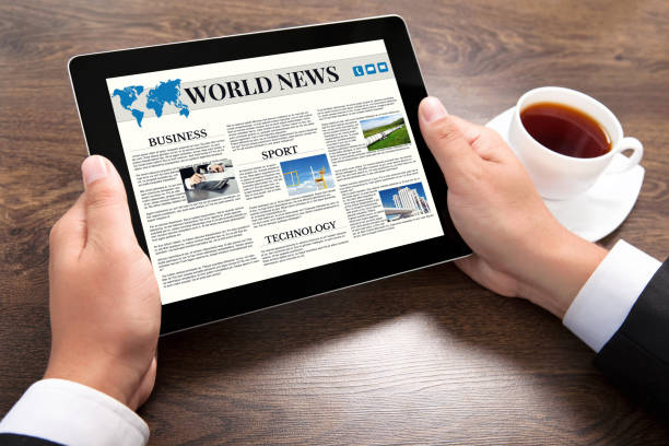 istock businessman holding tablet computer with world news site on screen 645841308