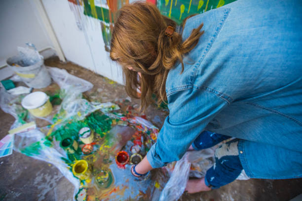 istock Blonde girl painting 645844470