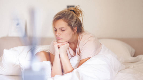 Young single woman in bed at home in the morning stock photo