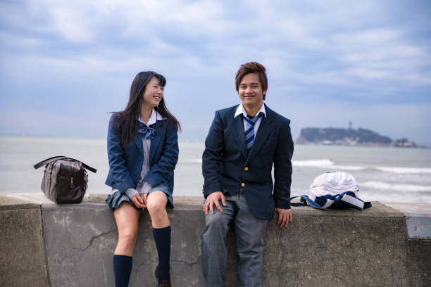 High school student couple being relaxed at beach High school student couple being relaxed at beach shonan photos stock pictures, royalty-free photos & images