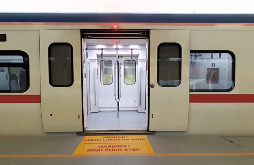 Train at station platform with open door
