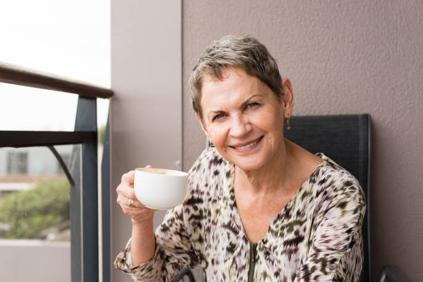 istock Older woman smiling with cup 645861230
